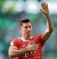 (FILES) In this file photo taken on May 14, 2022 Bayern Munich's Polish forward Robert Lewandowski greets and holds a hand on his heart after the German first division Bundesliga football match VfL Wolfsburg v Bayern Munich in Wolfsburg, northern Germany. - Bayern Munich's star Polish striker Robert Lewandowski is to be transferred to Barcelona for a fee of 45 million euros, plus 5 million in bonuses, several German media said on July 16, 2022. (Photo by Ronny Hartmann / AFP) / DFL REGULATIONS PROHIBIT ANY USE OF PHOTOGRAPHS AS IMAGE SEQUENCES AND/OR QUASI-VIDEO
