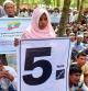 Rohingya refugees hold placards as they gather at the Kutupalong Refugee Camp to mark the fifth anniversary of their fleeing from neighbouring Myanmar to escape a military crackdown in 2017, in Cox's Bazar, Bangladesh, August 25, 2022. REUTERS/Rafiqur Rahman