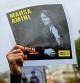 A protester shows a portrait of Mahsa Amini during a demonstration to support Iranian protesters standing up to their leadership over the death of a young woman in police custody, Sunday, Oct. 2, 2022 in Paris. Thousands of Iranians have taken to the streets over the last two weeks to protest the death of Mahsa Amini, a 22-year-old woman who had been detained by Iran's morality police in the capital of Tehran for allegedly not adhering to Iran's strict Islamic dress code. (AP Photo/Aurelien Morissard)