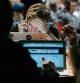 An attendee uses a mobile phone whilst looking at his laptop computer screen in the TechCrunch Disrupt London 2015 Hackathon in London, U.K., on Saturday, Dec. 5, 2015. Disrupt is an annual conference hosted by TechCrunch where some technology startups launch their products and services competing on stage in front of venture capital potential investors, media and other interested parties. Photographer: Luke MacGregor/Bloomberg