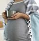 Pregnant woman wrapped in blanket with cup in hands drink hot tea. Natural treatment, remedies, homeopathy to treat illness while pregnancy. Herbal tea for healthy pregnance.