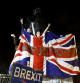 FILE PHOTO: People celebrate at the statue of Winston Churchill as Britain leaves the EU on Brexit day in London, Britain, January 31, 2020. REUTERS/Henry Nicholls/File Photo