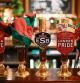 Festive elves' hats rest on beer pumps on the bar Hatter pub and hotel, operated by Fuller's, in London on November 30, 2022. - At The Mad Hatter pub, everything is ready: the huge Christmas tree, the luminous and golden garlands. On the bar sits signs that read: 