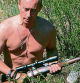 CROPPED VERSION - This pool picture provided 03 September 2007 shows Russian President Vladimir Putin carrying a hunting rifle in the Republic of Tuva, 15 August 2007. Putin is scheduled to visit Australia for the ASEAN conference starting this week. AFP PHOTO / RIA NOVOSTI / KREMLIN POOL / DMITRY ASTAKHOV (Photo by DMITRY ASTAKHOV / RIA NOVOSTI / AFP)