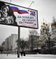 TOPSHOT - People walk past a poster dedicated to the upcoming Defender of the Fatherland Day which depicting a Russian soldier with a slogan reading 