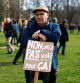 A protesters attends a demonstration against French government's pension reform plan in Paris, as part of the eighth day of national strike and protests in France, March 15, 2023. The sign reaads: