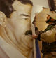 SAFWAN, IRAQ - MARCH 21: (NEWSWEEK AND U.S. NEWS OUT UNTIL 4/7/03) U.S. Marine Major Bull Gurfein pulls down a poster of Iraqi President Saddam Hussein March 21, 2003 in Safwan, Iraq. Chaos reigned in southern Iraq as coalition troops continued their offensive to remove Iraq's leader from power. (Photo by Chris Hondros/Getty Images)