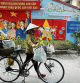 Hanoi (Vietnam), 21/10/2020.- A street vender walks past a mural on the wall in Hanoi, Vietnam, 21 October 2020. According to International Monetary Fund (IMF), Vietnam's GDP is estimated to grow at 1.6 percent in 2020. EFE/EPA/LUONG THAI LINH