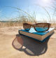 Book and sunglasses on the beach for summer reading and relaxing