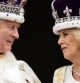 Britain's King Charles III and Queen Camilla look at each other as they stand on the balcony of the Buckingham Palace after their coronation, in London, Saturday, May 6, 2023. (Leon Neal/Pool Photo via AP)