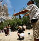 People take pictures, as a man makes bubbles, in front of Sagrada Familia, in Barcelona, Spain, May 24, 2023. REUTERS/Albert Gea