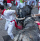 Participants run ahead of bulls during the 