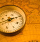 Vintage compass over antique map. T&S lens for selective focus.