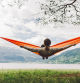 Young caucasian woman in hammock on the background of fjord in Norway