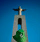 A person wearing a WYD hat stands in front of the Christ statue at the viewpoint of Christ Sanctuary in Almada, south of Lisbon, on July 28, 2023. Portugal is preparing to welcome Pope Francis and around a million young pilgrims for the World Youth Day (WYD) from August 1 to 6, 2023. (Photo by Patricia DE MELO MOREIRA / AFP)