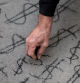 FILE PHOTO: A man draws a money symbol as people take part in a protest called Make Amazon Pay, at the building where CEO Jeff Bezos lives in Manhattan, New York, U.S., November 27, 2020. REUTERS/Eduardo Munoz/File Photo