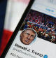 (FILES) In this file photo taken on August 10, 2020 a photo illustration, the Twitter account of US President Donald Trump is displayed on a mobile phone in Arlington, Virginia. - Twitter said January 8, 2021, it has permanently suspended President Donald Trump's account, citing the risk of further violence following the assault on the US Capitol by his supporters. (Photo by Olivier DOULIERY / AFP)