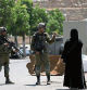 Israeli soldiers speak to a Palestinian woman near the site of an alleged car-ramming attack near Beit Hagai, a Jewish settlement in the hills south of the large Palestinian city of Hebron, Wednesday, Aug. 30, 2023. The Israeli military said security forces shot the Palestinian driver as he accelerated toward a military post. A soldier struck by the car was evacuated to a nearby hospital for treatment. There was no immediate word on the condition of the suspected Palestinian assailant. (AP Photo/Mahmoud Illean)
