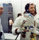 Apollo 11 Commander Neil Armstrong prepares to put on his helmet with the assistance of a spacesuit technician during suiting operations in the Manned Spacecraft Operations Building (MSOB) prior to the astronauts' departure to Launch Pad 39A. The three astronauts, Edwin E. Aldrin Jr., Neil A Armstrong and Michael Collins, will then board the Saturn V launch vehicle, scheduled for a 9:32 a.m. EDT liftoff, for the first manned lunar landing mission