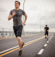 Two male athletes running together on overcast day, Montreal, Quebec, Canada