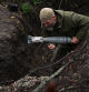 A Ukrainian serviceman carries a mortar shell as he fires toward Russian troops at a position in a front line, amid Russia's attack on Ukraine, at an undisclosed location in Donetsk region, Ukraine October 8, 2023. REUTERS/Stringer