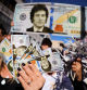FILE PHOTO: Supporters of Argentine presidential candidate Javier Milei hold dollar bills with his face on them, during a campaign rally, in Buenos Aires, Argentina September 25, 2023. REUTERS/Cristina Sille//File Photo