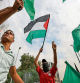 People lift flags during a rally near the French Embassy in Beirut, on October 31, 2023, in support of Palestinians in Gaza amid the ongoing conflict between Israel and the Hamas movement. (Photo by AHMAD AL-RUBAYE / AFP)