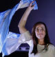 Argentina's vice presidential candidate for the La Libertad Avanza party, Victoria Villarruel, waves a national flag after winning the presidential election runoff outside the party headquarters in Buenos Aires on November 19, 2023. Argentina braced Sunday for the outcome of a knife-edge presidential election between Economy Minister Sergio Massa and outsider Javier Milei, who represent wildly different visions for the country's future. (Photo by Emiliano Lasalvia / AFP)