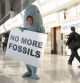 DUBAI, UNITED ARAB EMIRATES - DECEMBER 03: An environmental activist dressed as a dugong, a sea creature native to the United Arab Emirates, holds a sign that reads: 