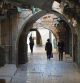 People walk past closed shops during a general strike in the Old City of Jerusalem on December 11, 2023, during a general strike in solidarity with Gaza, amid continuing battles between Israel and the Palestinian militant group Hamas. Palestinian groups called for a general strike on December 11 in solidarity with Gaza, and many shops, schools and government offices were shut across the occupied West Bank and annexed east Jerusalem. (Photo by AHMAD GHARABLI / AFP)