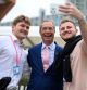 (FILES) Delegates pose for a photograph with former Leader of the Brexit Party, Nigel Farage (C), at the annual Conservative Party Conference in Manchester, northern England, on October 2, 2023. Anti-EU populist Nigel Farage's star turn on a popular reality TV show is fuelling speculation that the divisive figure may be plotting a sensational return to frontline British politics. (Photo by Oli SCARFF / AFP)