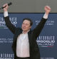 X (formerly Twitter) CEO Elon Musk raises his arms during the Atreju political meeting organised by the young militants of Italian right wing party Brothers of Italy (Fratelli d'Italia) on December 16, 2023 at the Sant'Angelo Castle in Rome. (Photo by Andreas SOLARO / AFP)