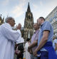 FILE - Same-sex couples take part in a public blessing ceremony in front of the Cologne Cathedral in Cologne, Germany, on Sept. 20, 2023. Pope Francis has formally approved allowing priests to bless same-sex couples, with a new document released Monday Dec. 18, 2023 explaining a radical change in Vatican policy by insisting that people seeking God’s love and mercy shouldn’t be subject to “an exhaustive moral analysis” to receive it. (AP Photo/Martin Meissner, File)
