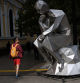 A pedestrian walks past a sculpture depicting Rodin's Thinker which is using AI to answer questions of locals, in Santiago, Chile, December 27, 2023. REUTERS/Ivan Alvarado