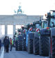 BERLIN, GERMANY - JANUARY 08: Tractors of protesting farmers line Strasse des 17. Juni street in front of the Brandenburg Gate on the first day of a week of protests on January 08, 2024 in Berlin, Germany. Farmers are protesting across Germany this week against proposed government measures that would reduce federal benefits for the agricultural sector. While the coalition government recently stepped back from some of the measures, including a proposed taxation of agricultural vehicles and cutting agricultural fuel subsidies, farmers have vowed to press on with their protests in order to stop any measures from being enacted at all. The government is seeking to save EUR 100 million in its agriculture budget. (Photo by Sean Gallup/Getty Images)