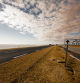 Desert road across dry salt lake Chott el Djerid in Tunisia.