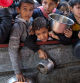 FILE PHOTO: Palestinian children wait to receive food cooked by a charity kitchen amid shortages of food supplies, as the ongoing conflict between Israel and the Palestinian Islamist group Hamas continues, in Rafah, in the southern Gaza Strip, February 5, 2024. REUTERS/Ibraheem Abu Mustafa/File Photo