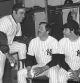 FILE - New York Yankees have a coffee break in the dressing room in Fort Lauderdale, Fla., in February 1977, before going out to work out the first day of baseball spring training. From left are coach Yogi Berra, Jim