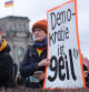 BERLIN, GERMANY - FEBRUARY 03: People, including one participant holding a sign that reads: