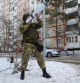 Local residents and self-defence unit volunteers participate in an evacuation drill during a simulated emergency over a Ukrainian shelling, in Belgorod, the main city of Russia's southwestern Belgorod region bordering Ukraine, on February 28, 2024. An anti-drone rifle is seen in the hands of a self-defence unit volunteer. (Photo by STRINGER / AFP)