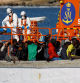 A group of migrants wait to disembark from a wooden boat after being rescued by a Spanish coast guard vessel in the port of Arguineguin, on the island of Gran Canaria, Spain, January 2, 2024. REUTERS/Borja Suarez