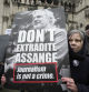 A protester holds a placard outside the Royal Courts of Justice in London, Wednesday, Feb. 21, 2024. Julian Assange's lawyers are on their final U.K. legal challenge to stop the WikiLeaks founder from being sent to the United States to face spying charges. The 52-year-old has been fighting extradition for more than a decade, including seven years in self-exile in the Ecuadorian Embassy in London and the last five years in a high-security prison. (AP Photo/Kin Cheung)