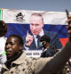 A banner of Russian President Vladimir Putin is seen during a protest to support the Burkina Faso President Captain Ibrahim Traore and to demand the departure of France's ambassador and military forces, in Ouagadougou, on January 20, 2023. (Photo by OLYMPIA DE MAISMONT / AFP)