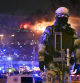 A Russian Rosguardia (National Guard) servicemen secures an area as a massive blaze seen over the Crocus City Hall on the western edge of Moscow, Russia, Friday, March 22, 2024. Several gunmen have burst into a big concert hall in Moscow and fired automatic weapons at the crowd, injuring an unspecified number of people and setting a massive blaze in an apparent terror attack days after President Vladimir Putin cemented his grip on the country in a highly orchestrated electoral landslide. (AP Photo/Dmitry Serebryakov)