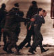 Russian special forces officers evacuate early 26 October 2002 unidentified hostageS from the Dubrovka theater in Moscow, where a number of Chechen rebels were holding some 700 theatre-goers hostage since 23 October. Thirty-six Chechen rebels were killed today when security forces stormed the building, Russian Deputy Interior Minister Vladimir Vasilyev said. Among the dead were all the Chechen kamikaze women who had explosives strapped to their bodies, he added. AFP PHOTO/ Alexander NEMENOV (Photo by Alexander NEMENOV / AFP)