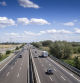 Piacenza, Italy - September 2017 cars and truck on motorway a1 autostrada del sole , daylight, serene sky with clouds.