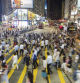 HONG KONG, HONG KONG - SEPTEMBER 23 2015: Pedestrians rush through a very busy intersection in the shopping district of Causeway Bay in Hong Kong island at night.