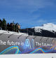 FILE PHOTO: People gather on top of Tata Consultancy Services pavilion on which a slogan related to Artificial Intelligence (AI) is displayed, during the 54th annual meeting of the World Economic Forum in Davos, Switzerland, January 16, 2024. REUTERS/Denis Balibouse/File Photo