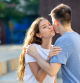 Young man and girl are hugging and kissing each other in cheek