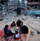 Members of Palestinian Abu Ghouta family eat their iftar meal as they break their fast near the rubble of their destroyed house during the holy month of Ramadan, amid the ongoing conflict between Israel and Hamas, in Rafah in the southern Gaza Strip, March 21, 2024. REUTERS/Mohammed Salem